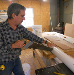 Sawing pipes to build a garden tower.