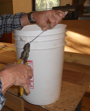 Preparing buckets to build a garden tower.