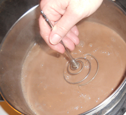 Heating the cream in the goat milk ice cream recipe.