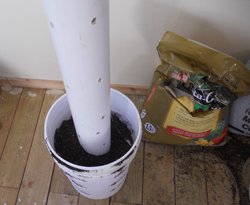 Adding soil to a homemade garden tower.